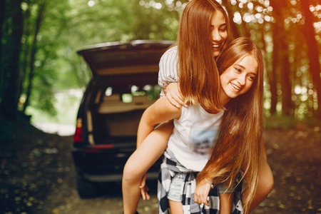 Two girls near carの写真素材