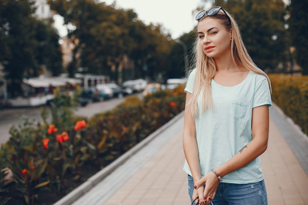 Cute girl with shopping bag in a cityの写真素材
