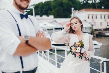 Beautiful bride with her husband in a parkの写真素材