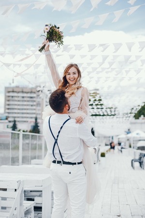 Beautiful bride with her husband in a parkの写真素材