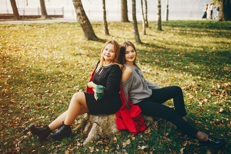 cute girls in a autumn parkの写真素材