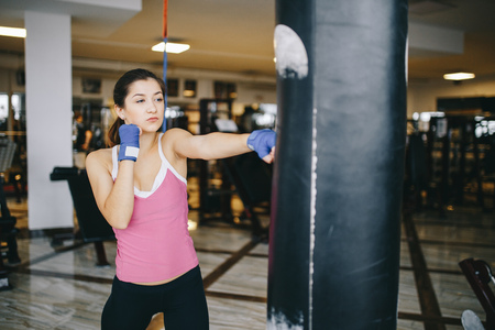A beautiful girl is engaged in a gym