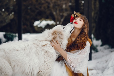 Elegant woman in a long white dressの写真素材