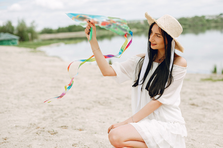 Elegant and stylish girl in a spring parkの写真素材