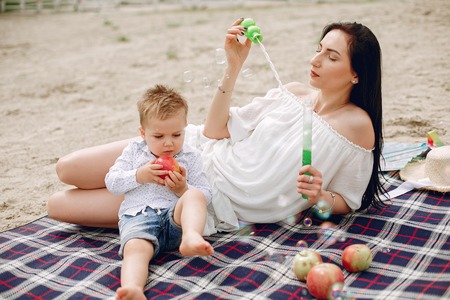 Mother with son playing in a summer parkの写真素材