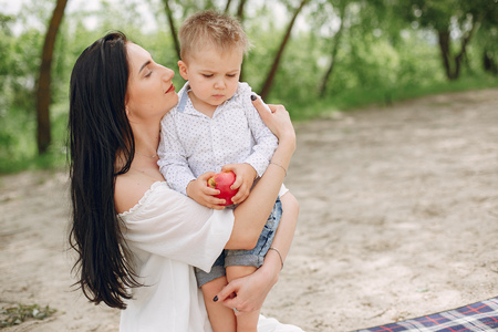 Mother with son playing in a summer parkの写真素材