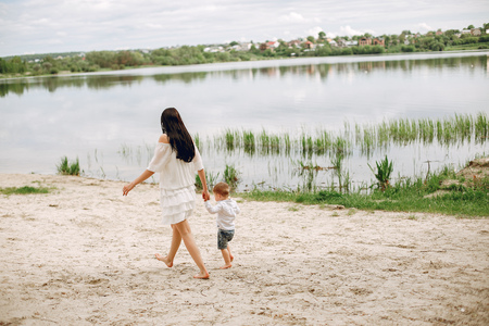 Mother with son playing in a summer parkの写真素材