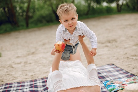 Mother with son playing in a summer parkの写真素材