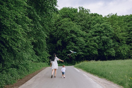 Mother with son playing in a summer parkの写真素材