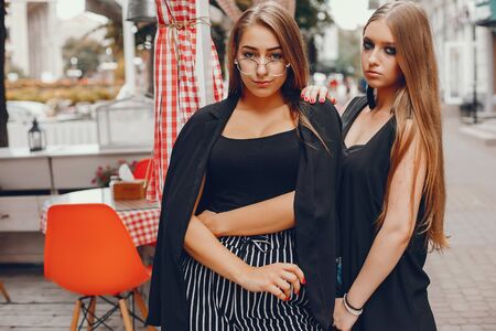 Fashion girls walking in a summer cityの写真素材