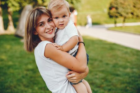 Mother with son playing in a summer parkの写真素材