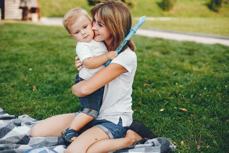 Mother with son playing in a summer parkの写真素材