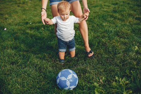 Mother with son playing in a summer parkの写真素材
