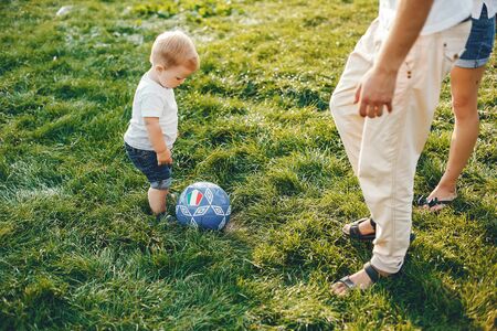 Family with son playing in a summer parkの写真素材