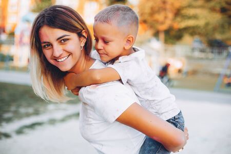Mother with son playing in a summer parkの写真素材
