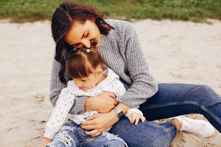 Mother with daughter playing in a summer parkの写真素材