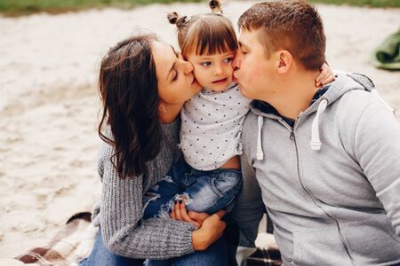 Fathet with daughter playing on a sandの写真素材