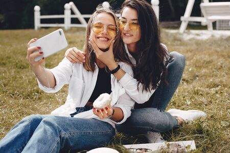 Two pretty girls in a summer park