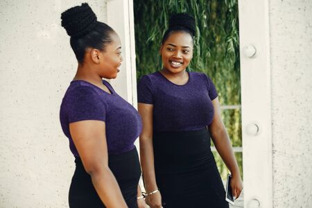 Beautiful black girl standing in a sumer parkの写真素材