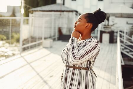 Beautiful black girl standing in a summer parkの写真素材