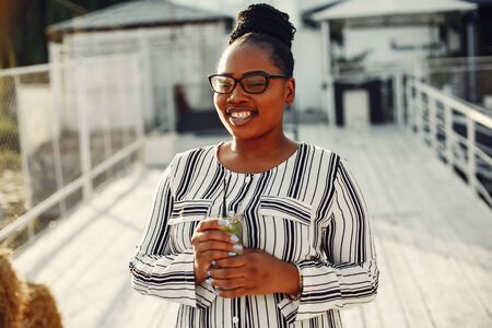 Beautiful black girl standing in a summer parkの写真素材