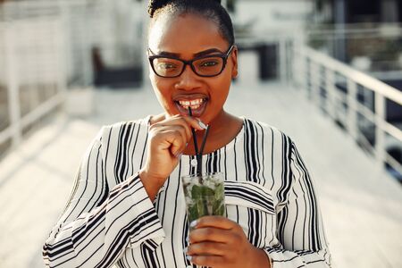 Beautiful black girl standing in a summer parkの写真素材