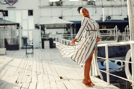 Beautiful black girl standing in a summer parkの写真素材