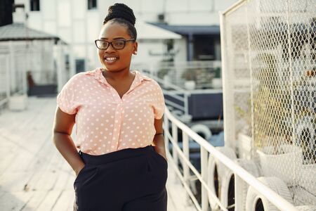 Beautiful black girl standing in a summer parkの写真素材