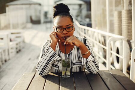 Beautiful black girl standing in a summer parkの写真素材