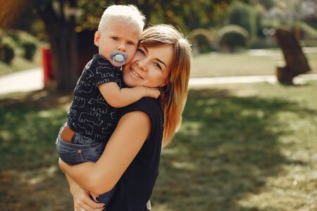 Mother with son playing in a summer park