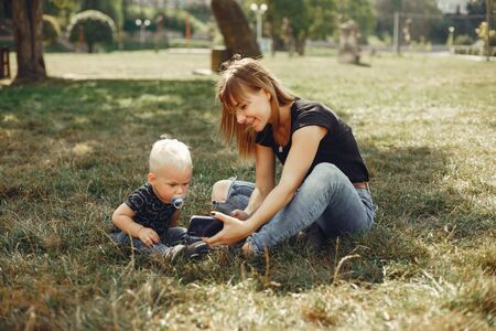 Mother with son playing in a summer parkの写真素材