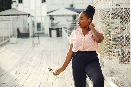Beautiful black girl standing in a summer parkの写真素材