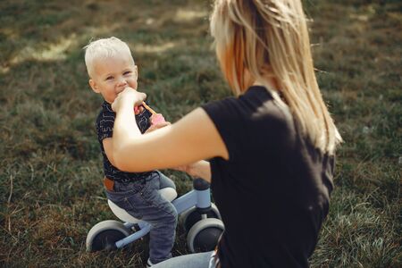 Mother with son playing in a summer parkの写真素材