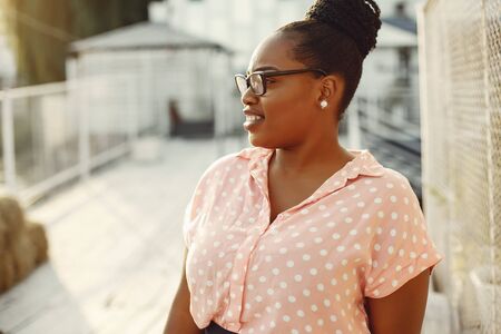 Beautiful black girl standing in a summer park