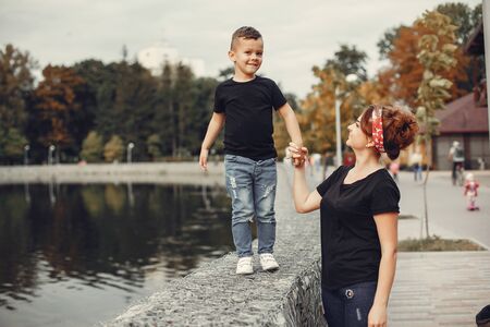 Mother with son playing in a summer parkの写真素材