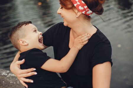 Mother with son playing in a summer parkの写真素材