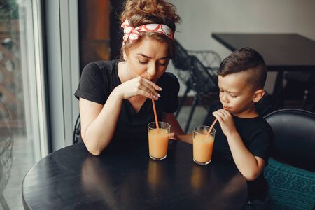 Mother with son sitting in a cafeの写真素材