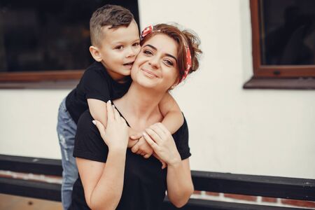 Mother with son playing in a summer cityの写真素材