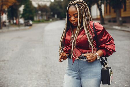 Elegant black girl in a summer city