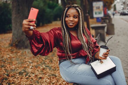 Elegant black girl in a summer cityの写真素材