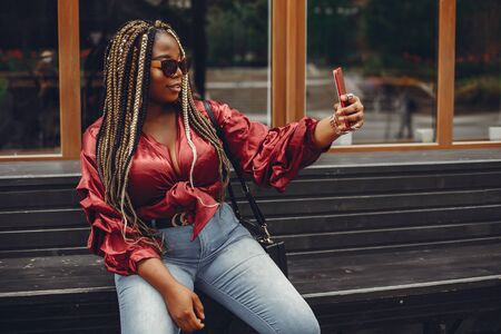 Elegant black girl in a summer cityの写真素材
