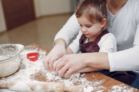 Family cook the dough for cookies