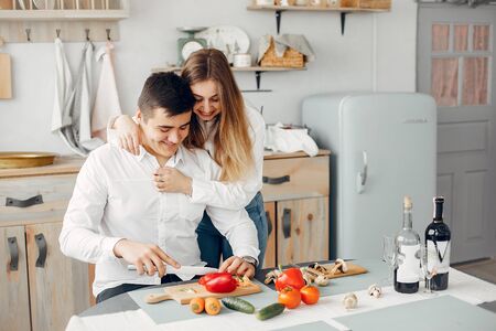 Beautiful couple prepare food in a kitchenの写真素材