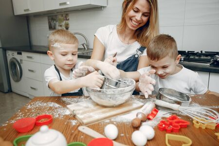 Family cook the dough for cookies