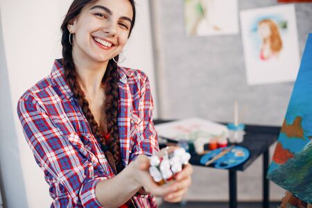 Elegant girl draws in an art studioの写真素材
