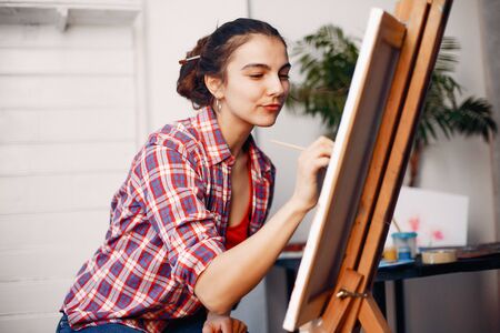 Elegant girl draws in an art studioの写真素材