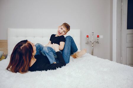 Beautiful mother with cute son at homeの写真素材