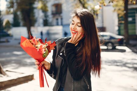 Fashion girl walking in a summer cityの写真素材