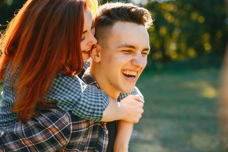 Beautiful couple spend time in a summer parkの写真素材