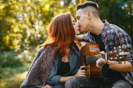 Beautiful couple spend time in a summer parkの写真素材